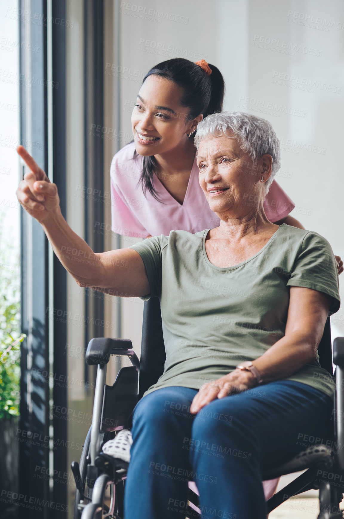 Buy stock photo Shot of a young nurse standing beside an older woman in a wheelchair