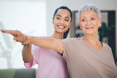 Buy stock photo Shot of an older woman doing light stretching exercises during a session with a physiotherapist inside