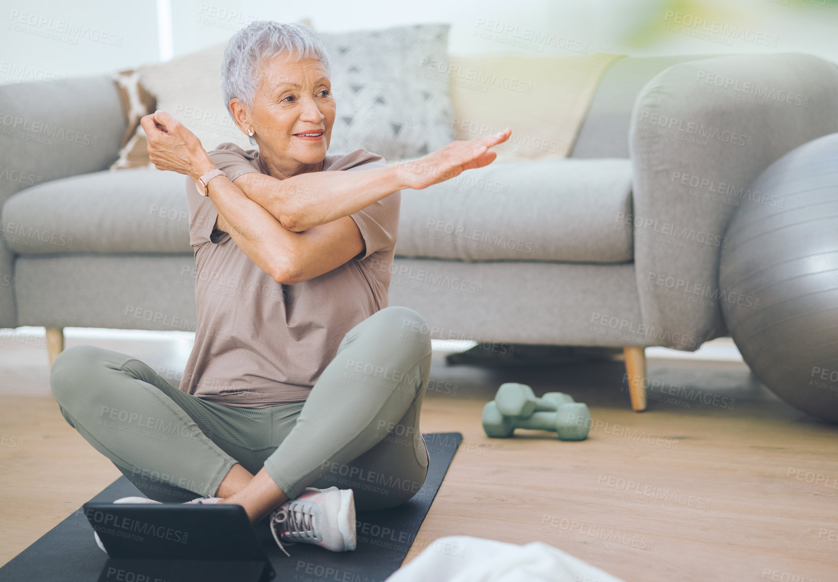 Buy stock photo Shot of an older woman doing light floor exercises at home