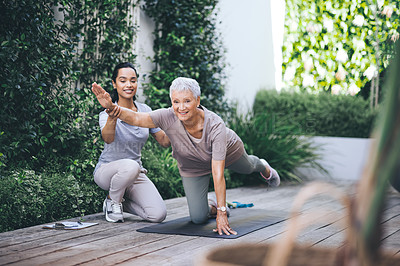 Buy stock photo Shot of an older woman doing light floor exercises during a session with a physiotherapist outside