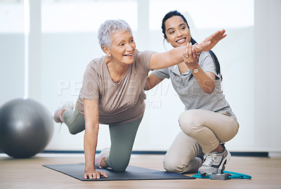 Buy stock photo Shot of an older woman doing light floor exercises during a session with a physiotherapist