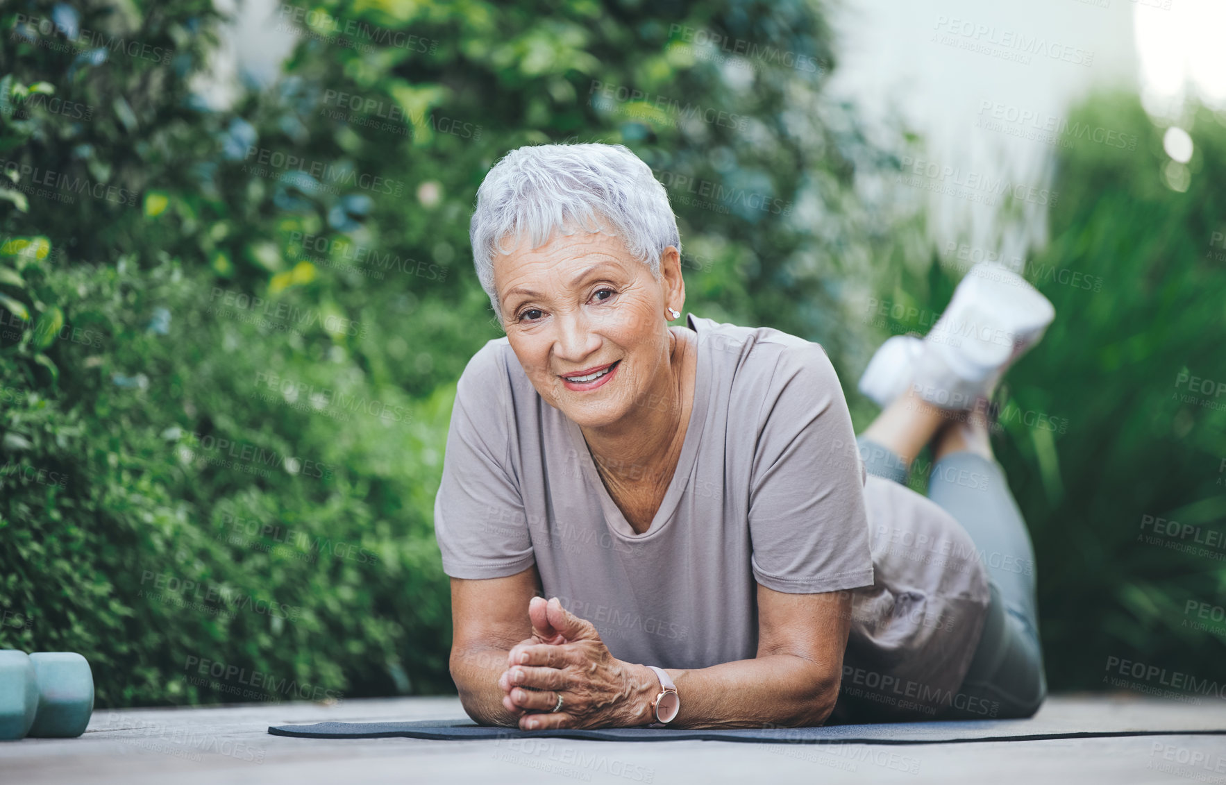 Buy stock photo Portrait of an older woman relaxing during her workout on the floor outside