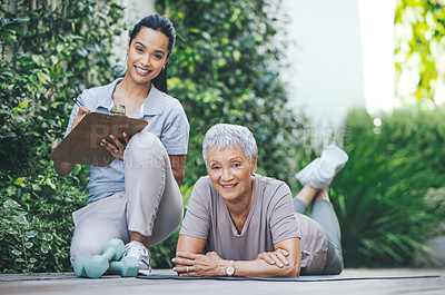Buy stock photo Portrait of an older woman relaxing during her workout on the floor during a session with a physiotherapist outside