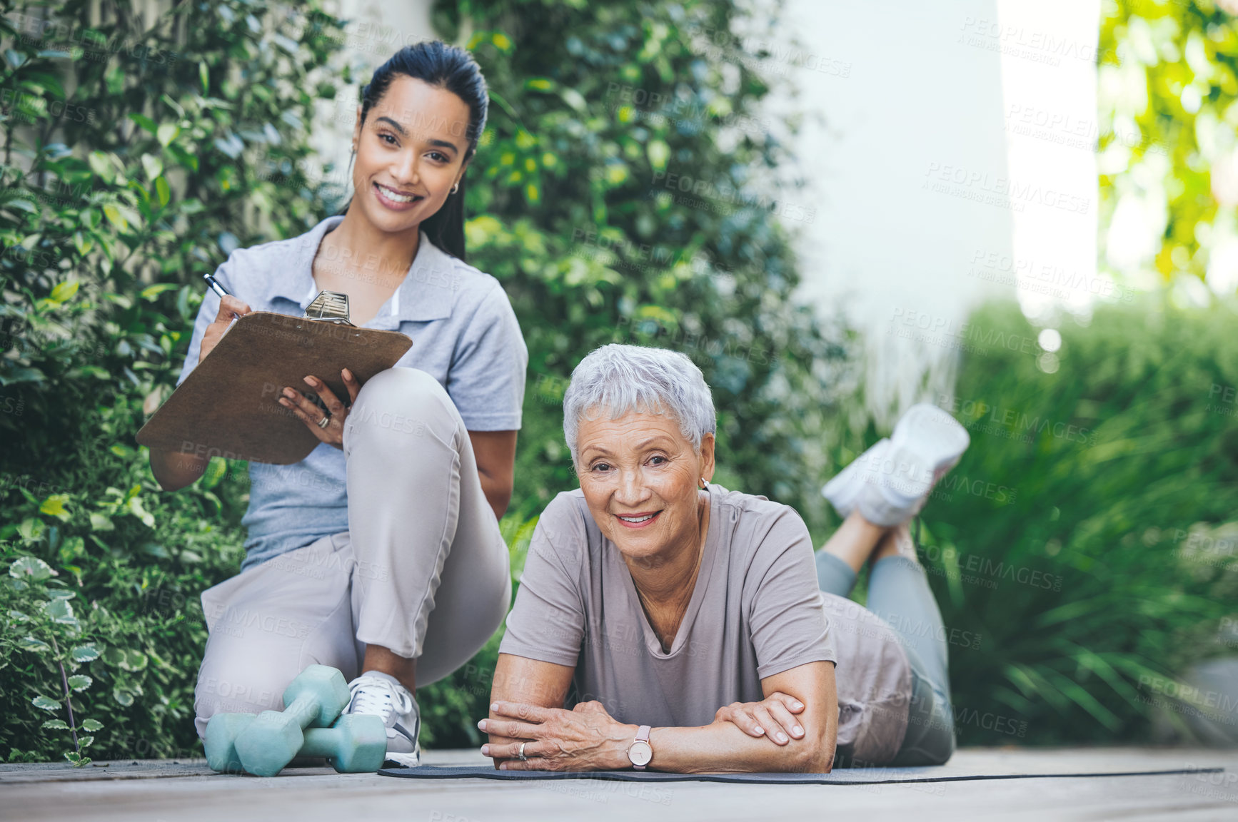 Buy stock photo Portrait of an older woman relaxing during her workout on the floor during a session with a physiotherapist outside