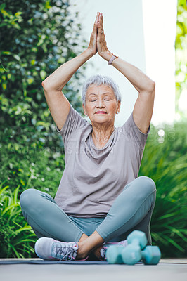 Buy stock photo Shot of an older woman in deep meditation outside