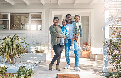 Buy stock photo Portrait of a happy family standing together outside their home