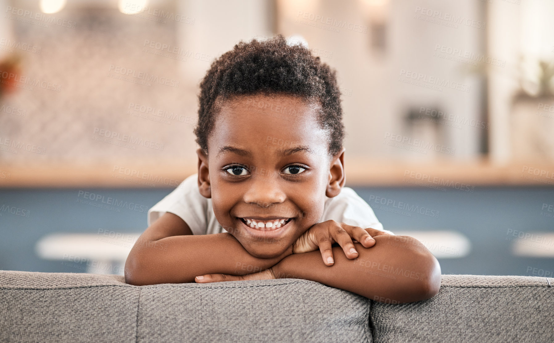 Buy stock photo Portrait of an adorable little boy relaxing on the sofa at home