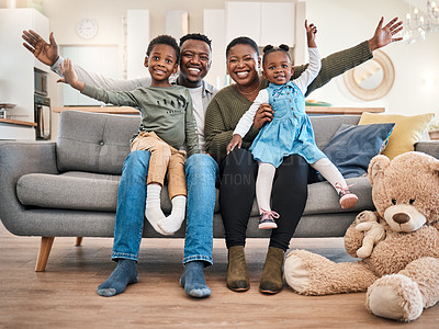 Buy stock photo Portrait of a happy young family having fun on the sofa at home