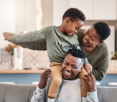 Buy stock photo Shot of a happy young family playing together on the sofa at home