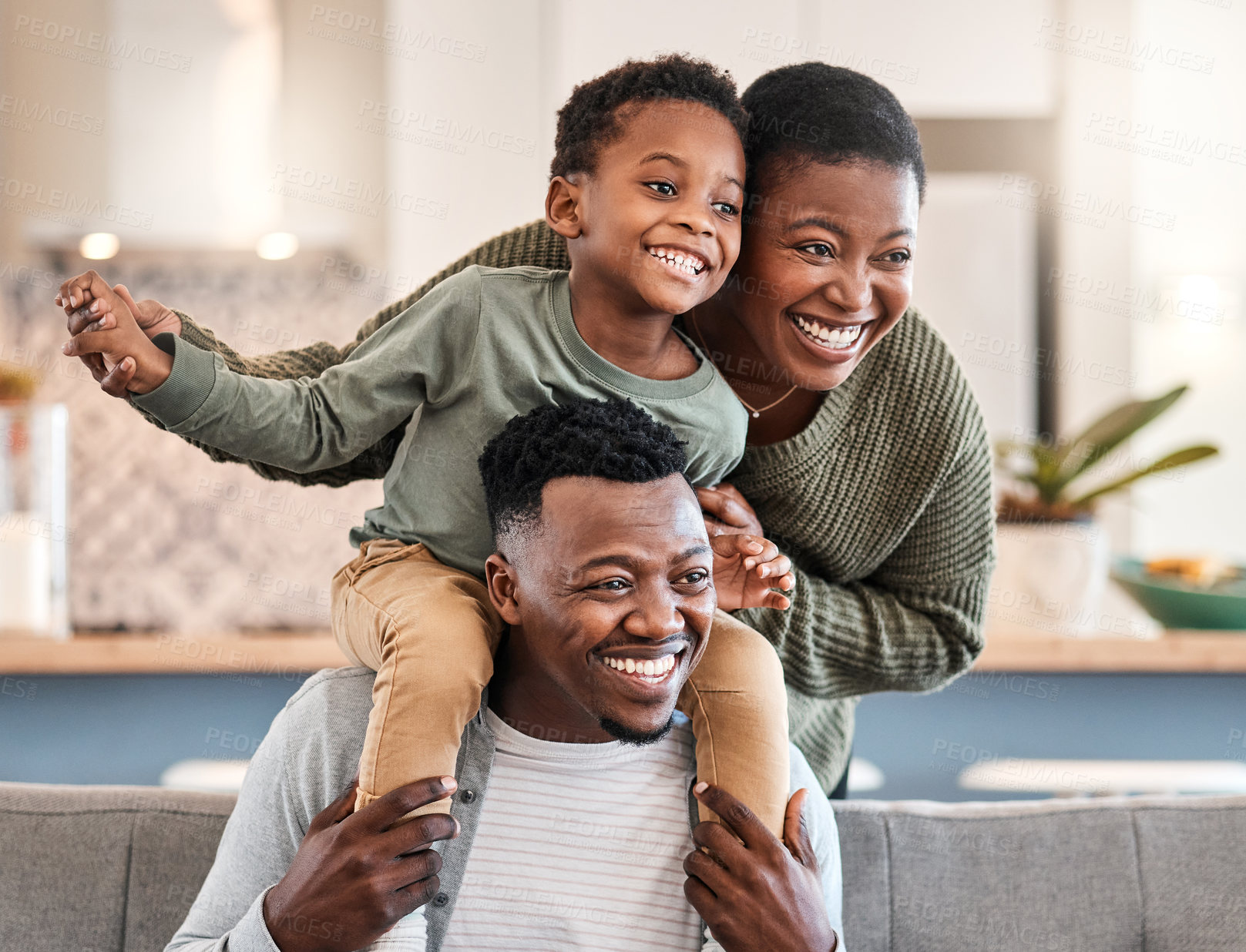 Buy stock photo Shot of a happy young family playing together on the sofa at home