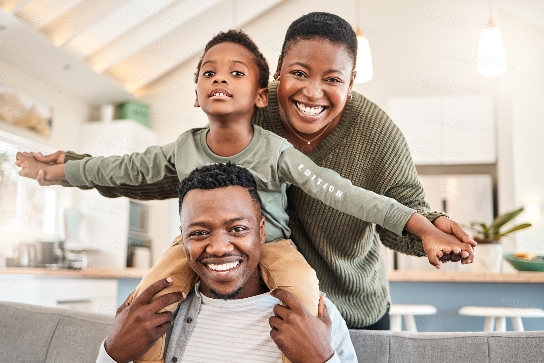 Buy stock photo Shot of a happy young family playing together on the sofa at home