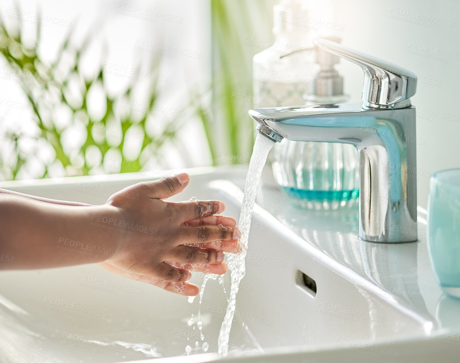 Buy stock photo Closeup shot of an unrecognisable boy washing his hands at a tap in a bathroom at home