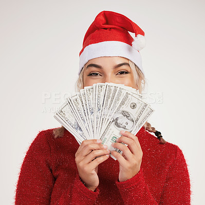 Buy stock photo Studio shot of a young woman posing with money against a grey background