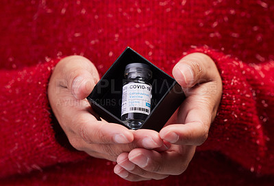 Buy stock photo Studio shot of a unrecognizable woman holding a vaccine against a grey background