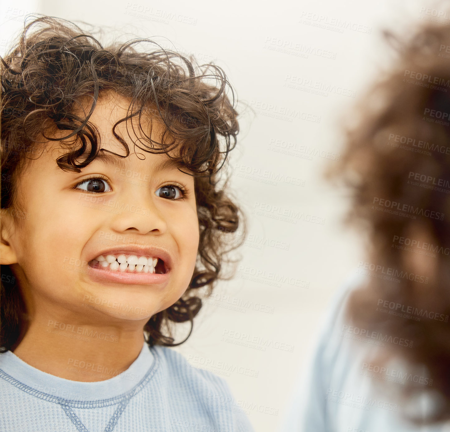 Buy stock photo Shot of a little boy checking his teeth in the mirror at home