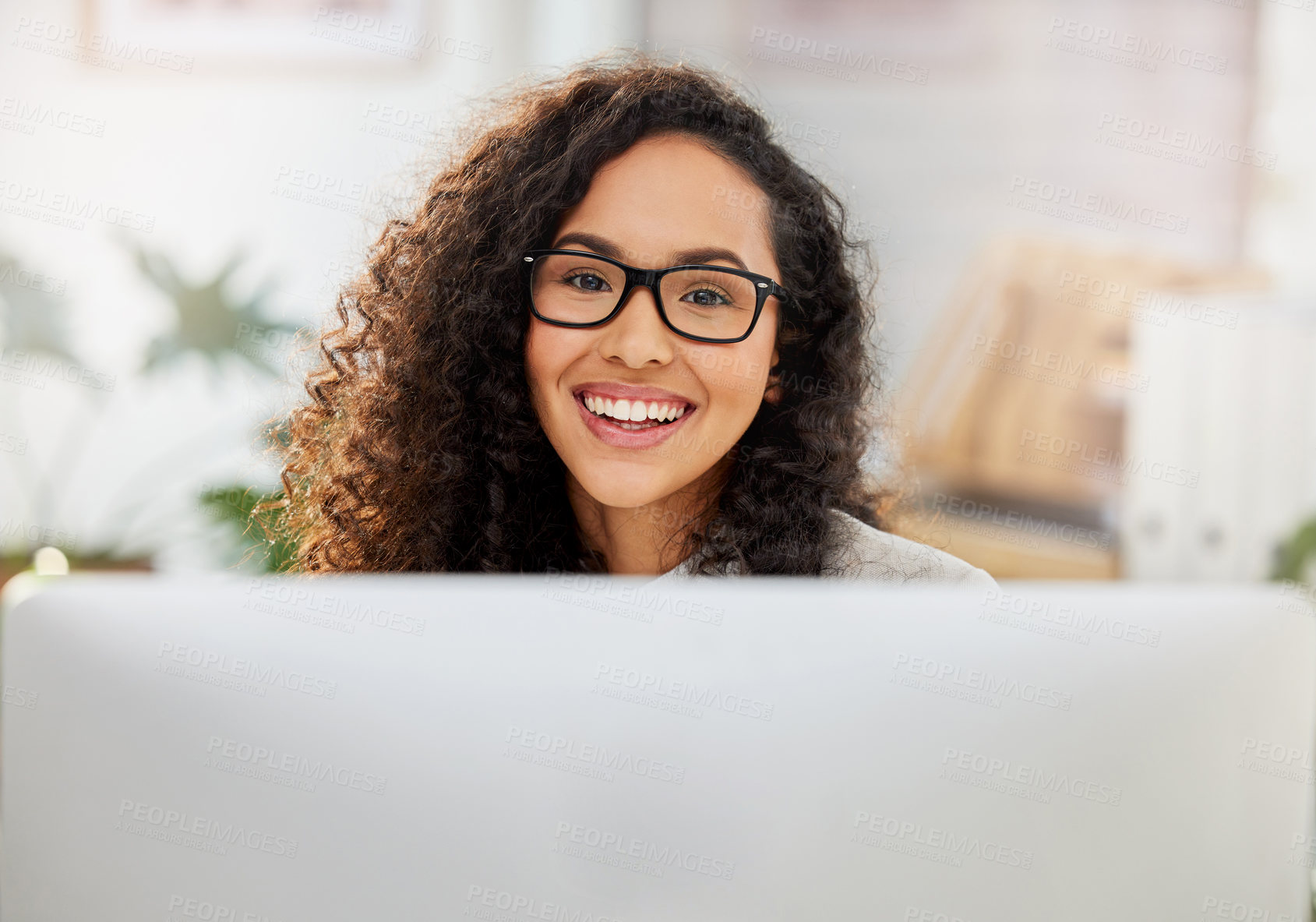 Buy stock photo Portrait of a young businesswoman working on a computer in an office