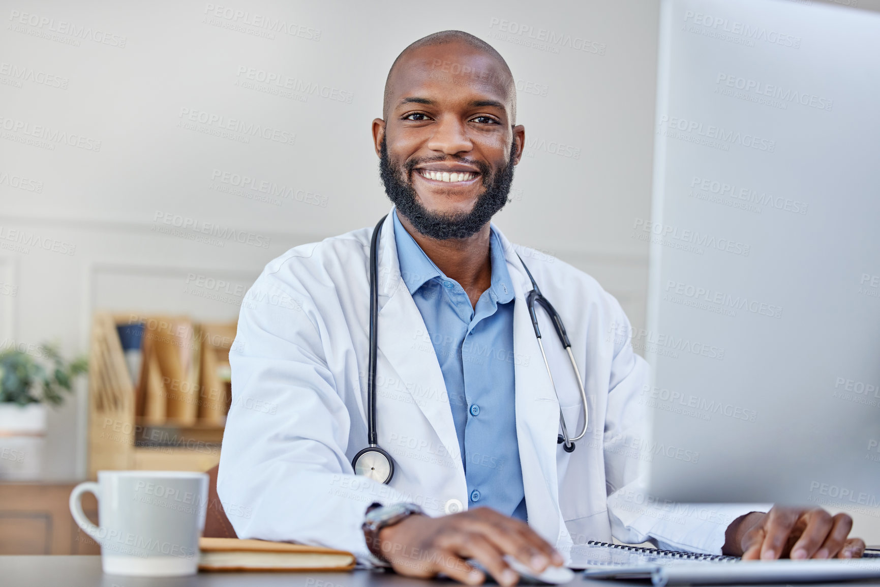 Buy stock photo Smile, portrait and black man doctor with computer in hospital office for medical telehealth. Happy, typing and African healthcare worker with research for treatment or diagnosis on desktop in clinic