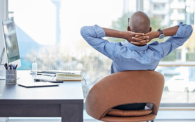 Buy stock photo Shot of a businessman looking relaxed while sitting in his office