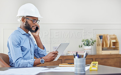 Buy stock photo Shot of an architect using his tablet while talking on his cellphone