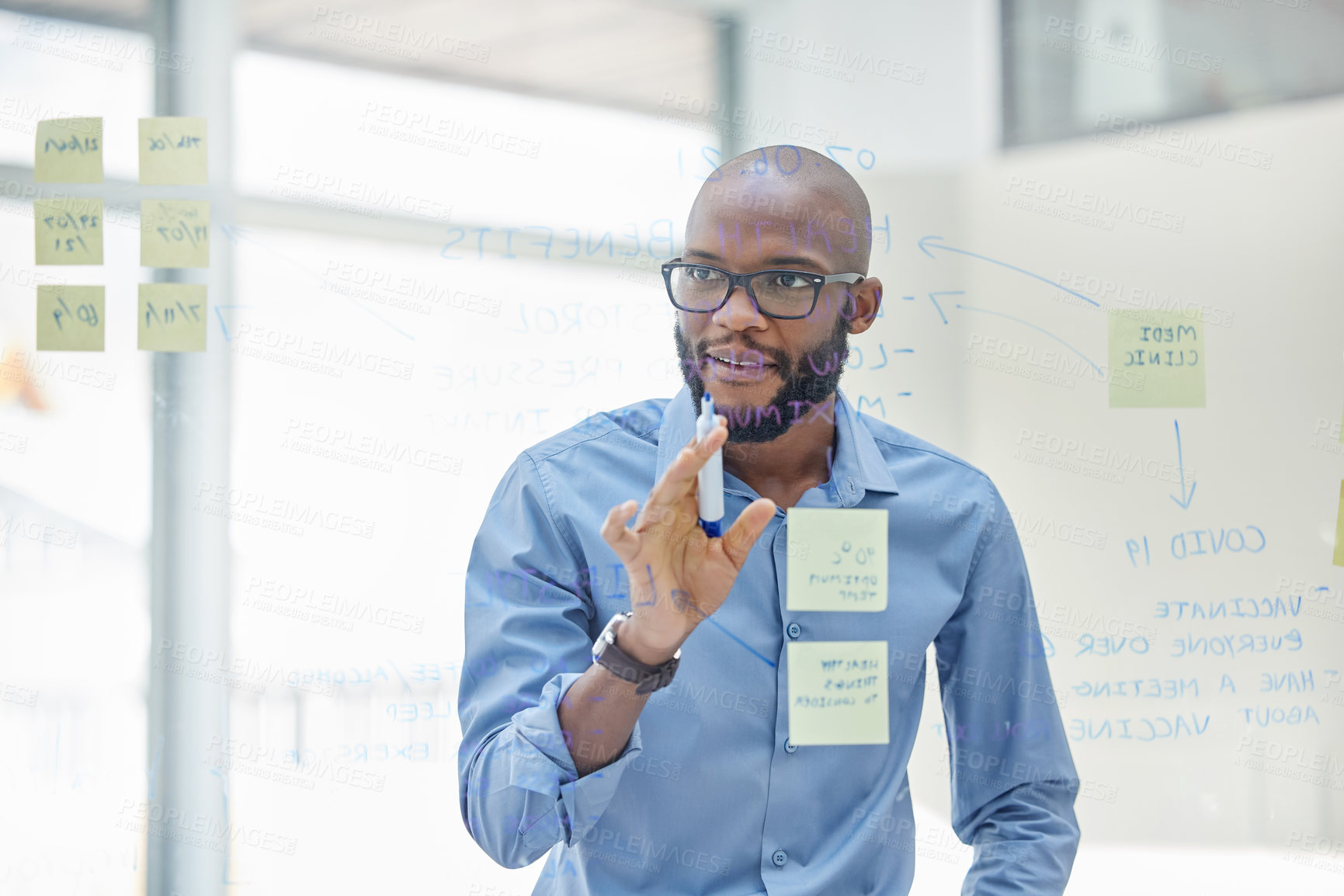 Buy stock photo Black man, office and employee on glass board for brainstorming or ideas with sticky notes for business. Project manager, smile and task with strategy, planning and write vision for company growth