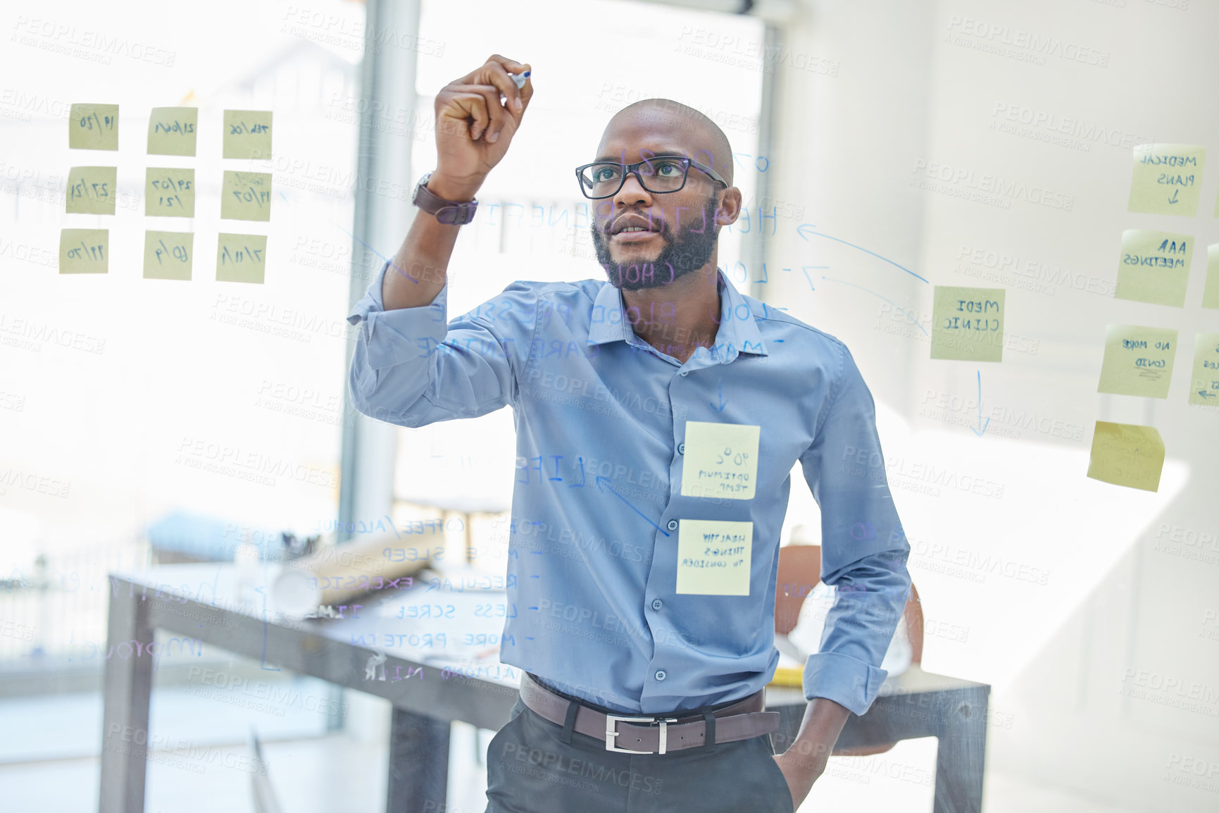 Buy stock photo Black man, office and writing on glass board for brainstorming or ideas with sticky notes for business. Project manager, employee and confident with strategy, planning and task for company growth