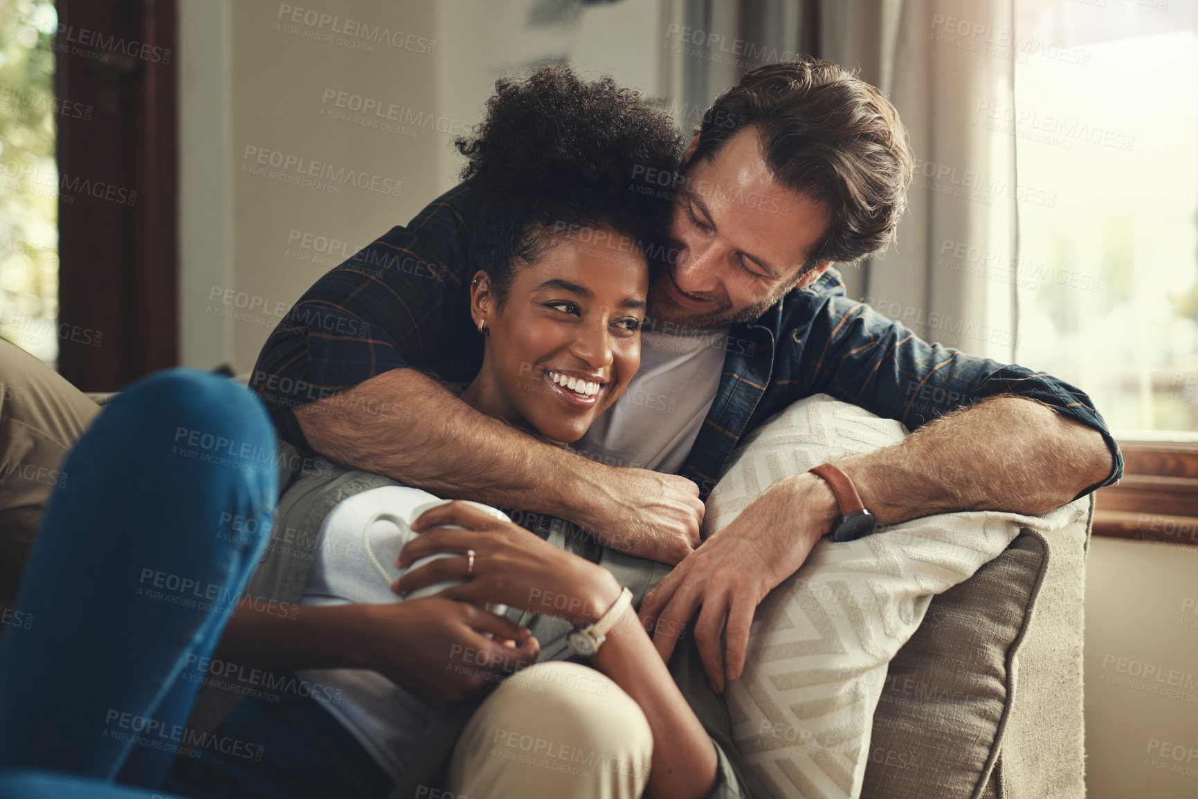 Buy stock photo Home, happy and couple with hug on sofa for weekend romance, partnership and bonding together. Man, love and woman with affection in living room on couch for connection, support and trust in marriage