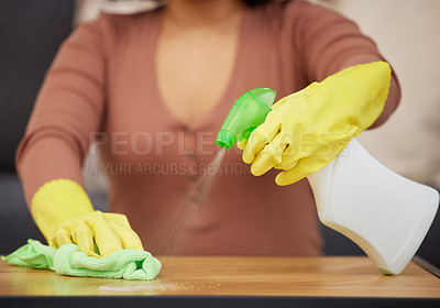 Buy stock photo Cropped shot of an unrecognizable woman using detergent and a cloth to wipe the tabletops at home