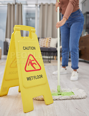 Buy stock photo Cropped shot of an unrecognizable woman mopping her living room floor at home