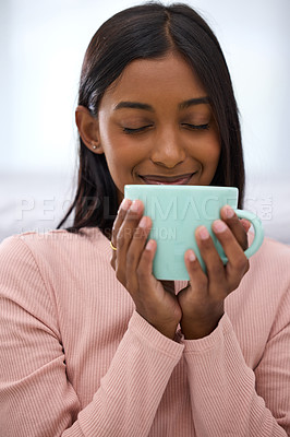 Buy stock photo Cropped shot of an attractive young woman enjoying a fresh cup of coffee at home