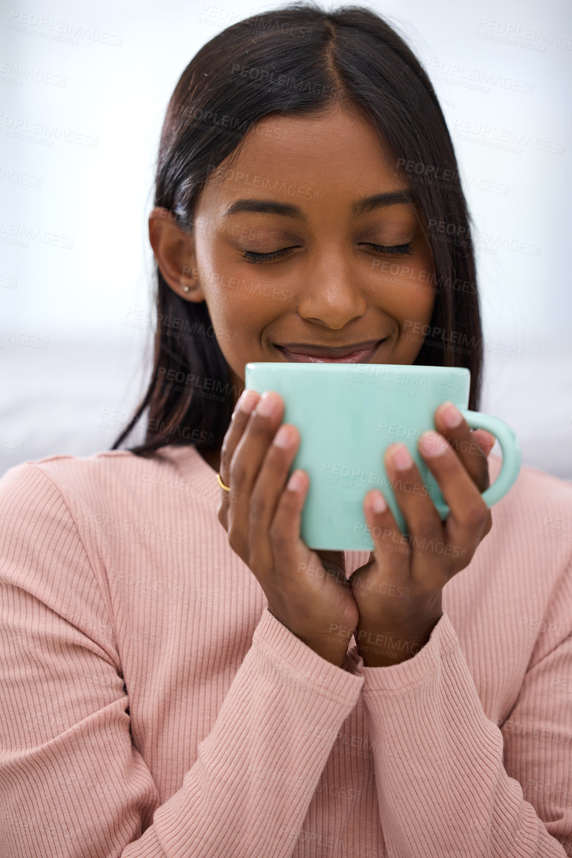 Buy stock photo Cropped shot of an attractive young woman enjoying a fresh cup of coffee at home