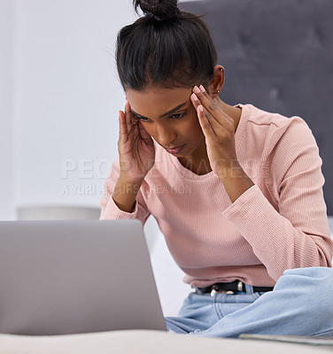 Buy stock photo Cropped shot of an attractive young woman looking stressed while working on her laptop in the bedroom at home