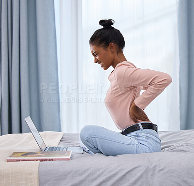 Buy stock photo Woman, laptop and pain in back on bed for elearning with muscle injury, online class and bad posture. Indian student, tech and body with tension in home bedroom for tendinitis and school studying