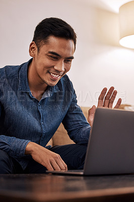 Buy stock photo Shot of a young man using his laptop to make a video call