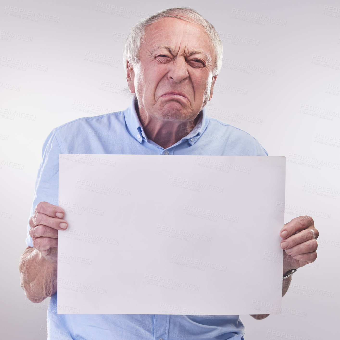 Buy stock photo Studio shot of a senior man holding a blank sign and looking unhappy against a grey background