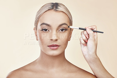 Buy stock photo Studio shot of a woman having makeup applied to her face