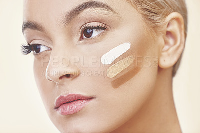 Buy stock photo Studio shot of a woman posing with different shades of makeup on her cheek