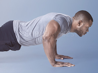 Buy stock photo Man, push up and fitness with strong exercise, wellness and training with strength and arm health. Studio, active athlete and muscle with gym practice and blue background with workout and sport