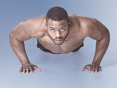 Buy stock photo Man, push up and fitness portrait with strong exercise, wellness and training with strength and arm health. Studio, athlete and muscle with gym practice and blue background with workout and sport