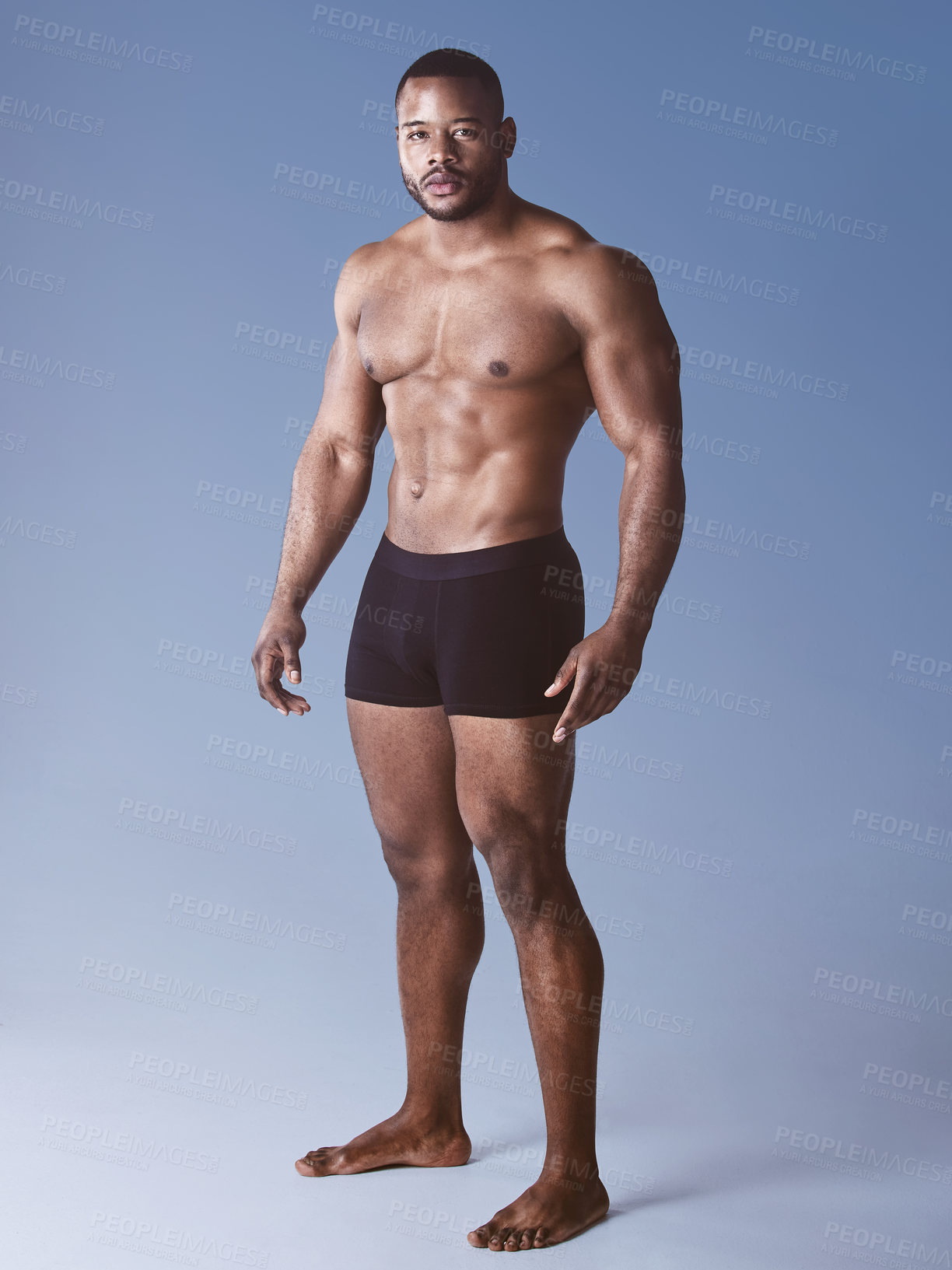 Buy stock photo Black man, portrait and underwear for fitness in studio, wellness and strong on blue background. Male person, athlete and proud bodybuilder for training, exercise and results of workout challenge