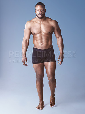 Buy stock photo Black man, portrait and bodybuilder for fitness in studio, wellness and strong on blue background. Male person, athlete and proud for muscle development, exercise and results of workout challenge