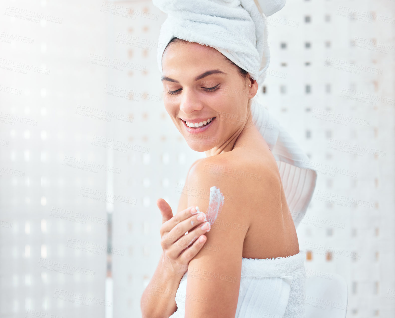 Buy stock photo Woman, towel and moisturizing lotion in bathroom for healthy skincare, application or morning routine. Female person, shoulder and smile or dermatology cream with cleaning hygiene, shower or home