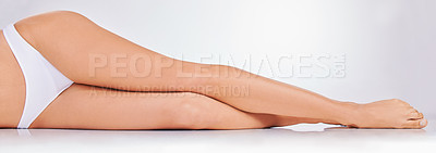 Buy stock photo Legs, woman and waxing for clean, smooth and laser treatment in hair removal, skincare or epilation in studio. Feet, grooming and slim person for hygiene, cosmetic or dermatology in white background
