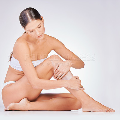 Buy stock photo Hair removal, skin and woman with cream in studio for natural cosmetic, epilation or grooming on white background. Body, legs and model on floor for organic treatment, wellness or satisfaction