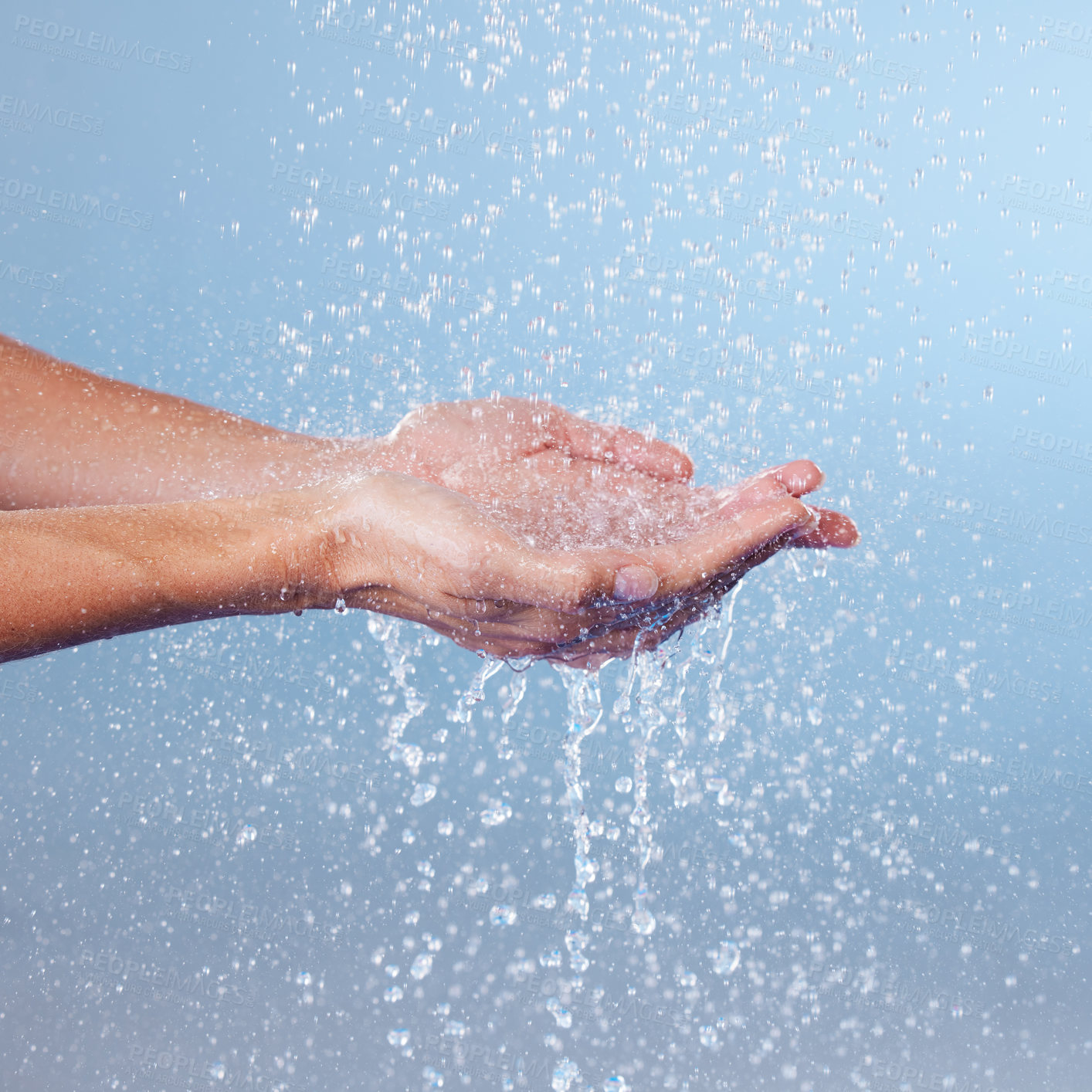 Buy stock photo Person, hands and water for hygiene in studio, washing and grooming for skincare on blue background. Palms, cleaning and liquid for cosmetics or bacteria and germ protection, disinfect and hydration