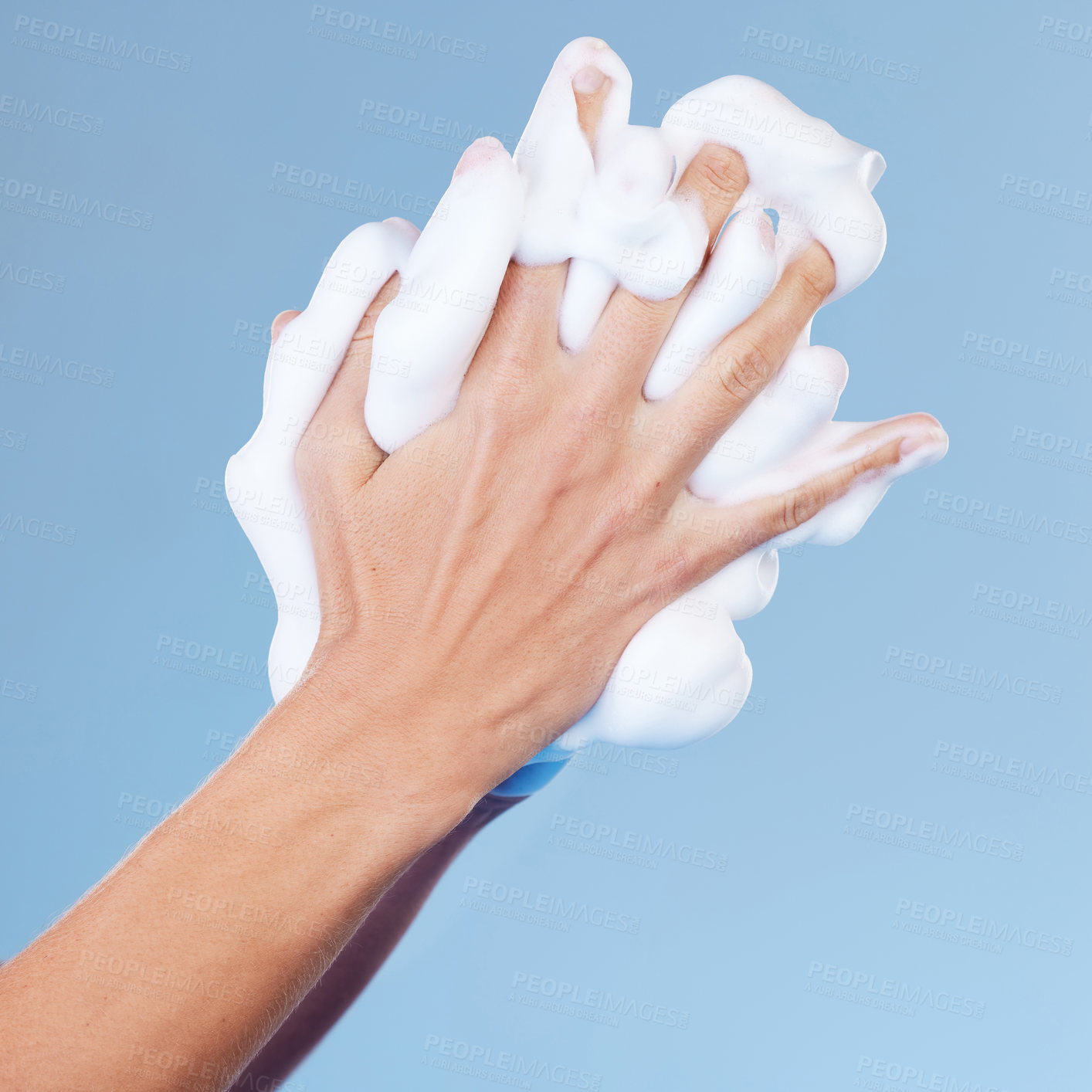 Buy stock photo Person, hands and foam for washing in studio, disinfection and grooming for skincare on blue background. Palms, cleaning and soap for cosmetics or bacteria and germ protection, beauty and sanitary