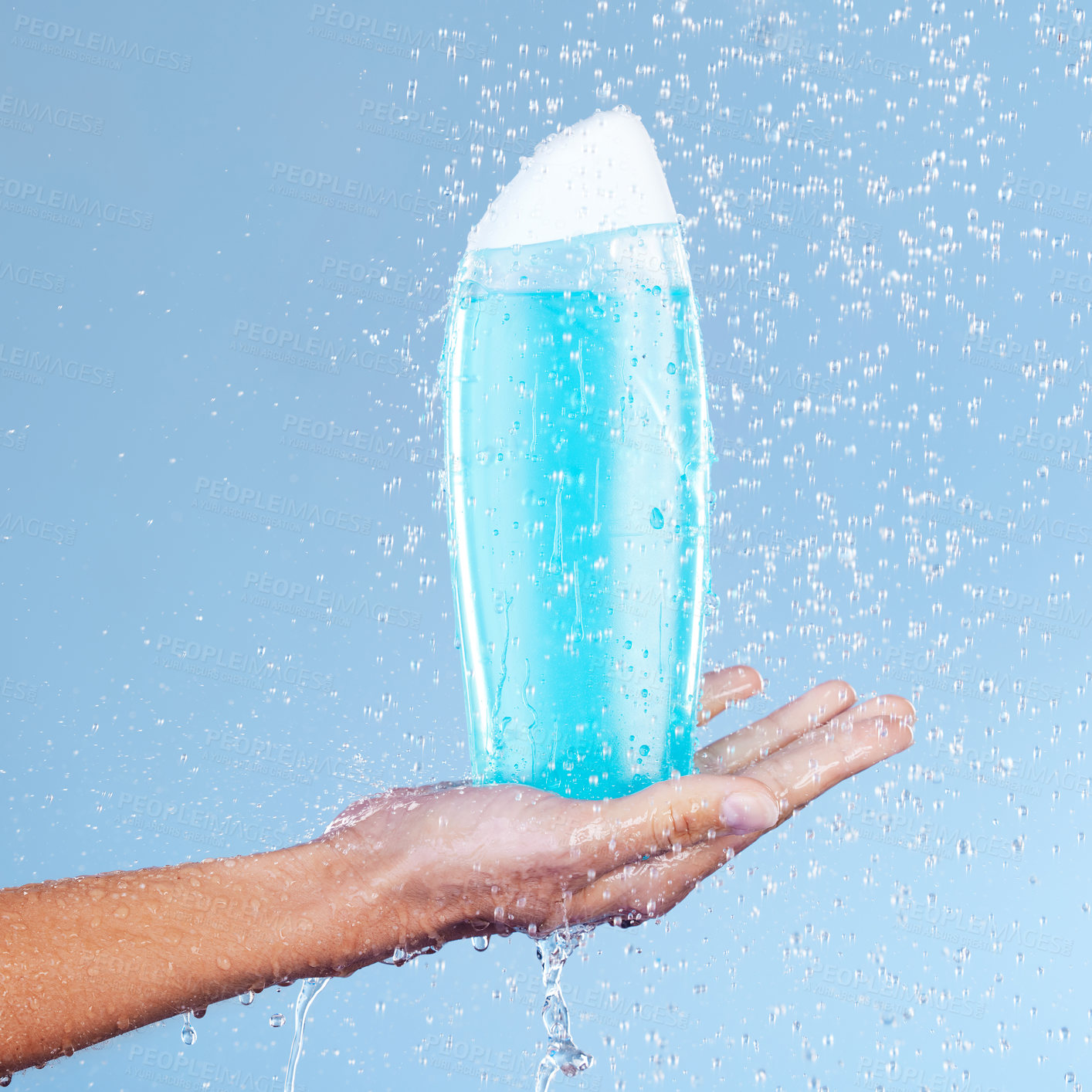 Buy stock photo Person, hand and shampoo bottle under water in studio, cosmetics and shower gel on blue background. Palm, body care and cleaning or grooming for treatment, hygiene and liquid for haircare or soap