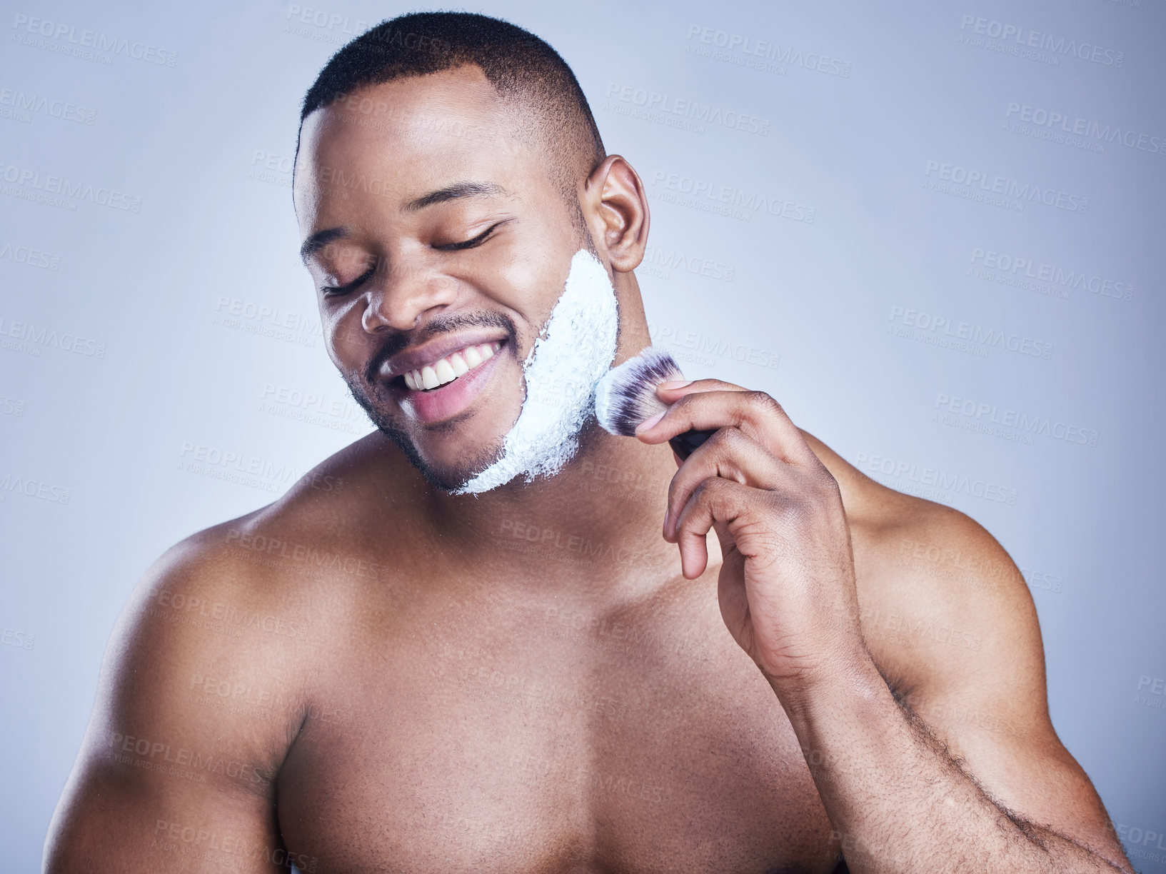 Buy stock photo Black man, brush and apply shaving foam in studio, beauty and grooming routine for hair removal. Male person, cream and hygiene or facial treatment for skincare, cleaning and tool on blue background