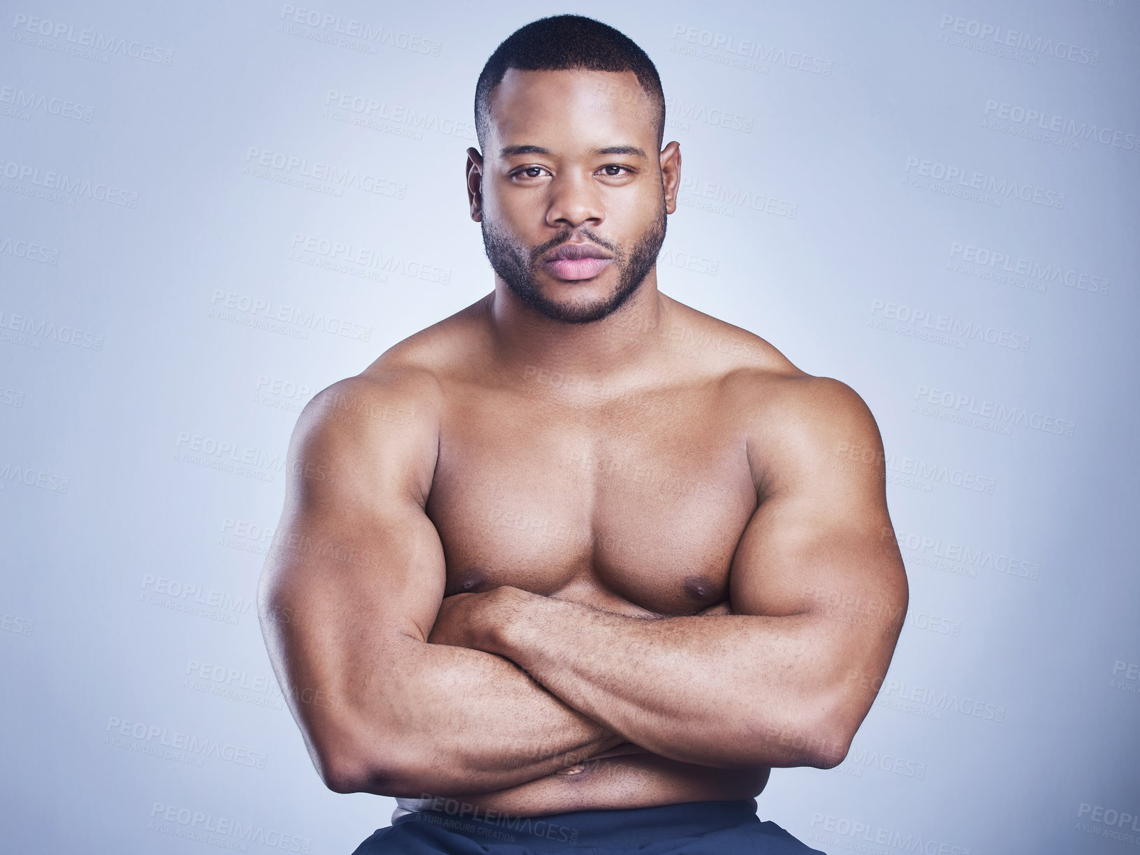 Buy stock photo Black man, arms crossed and shirtless in studio with fitness for healthy body, portrait and muscle with confidence. Bodybuilder, athlete and serious with wellness and arm strength on blue background