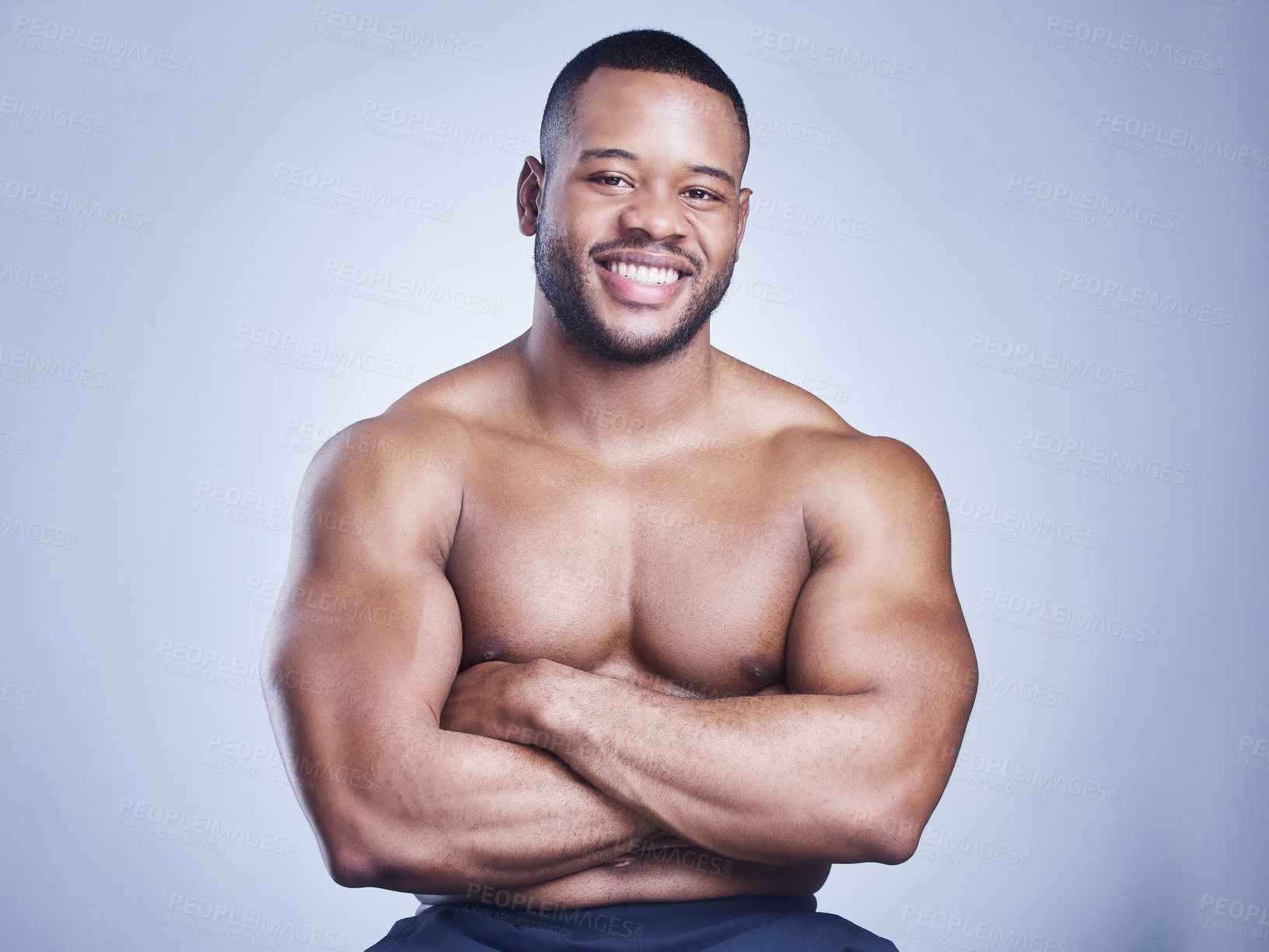 Buy stock photo Black man, arms crossed and shirtless in studio with smile for healthy body, portrait and fitness with confidence. Bodybuilder, athlete and power with wellness and arm strength on blue background