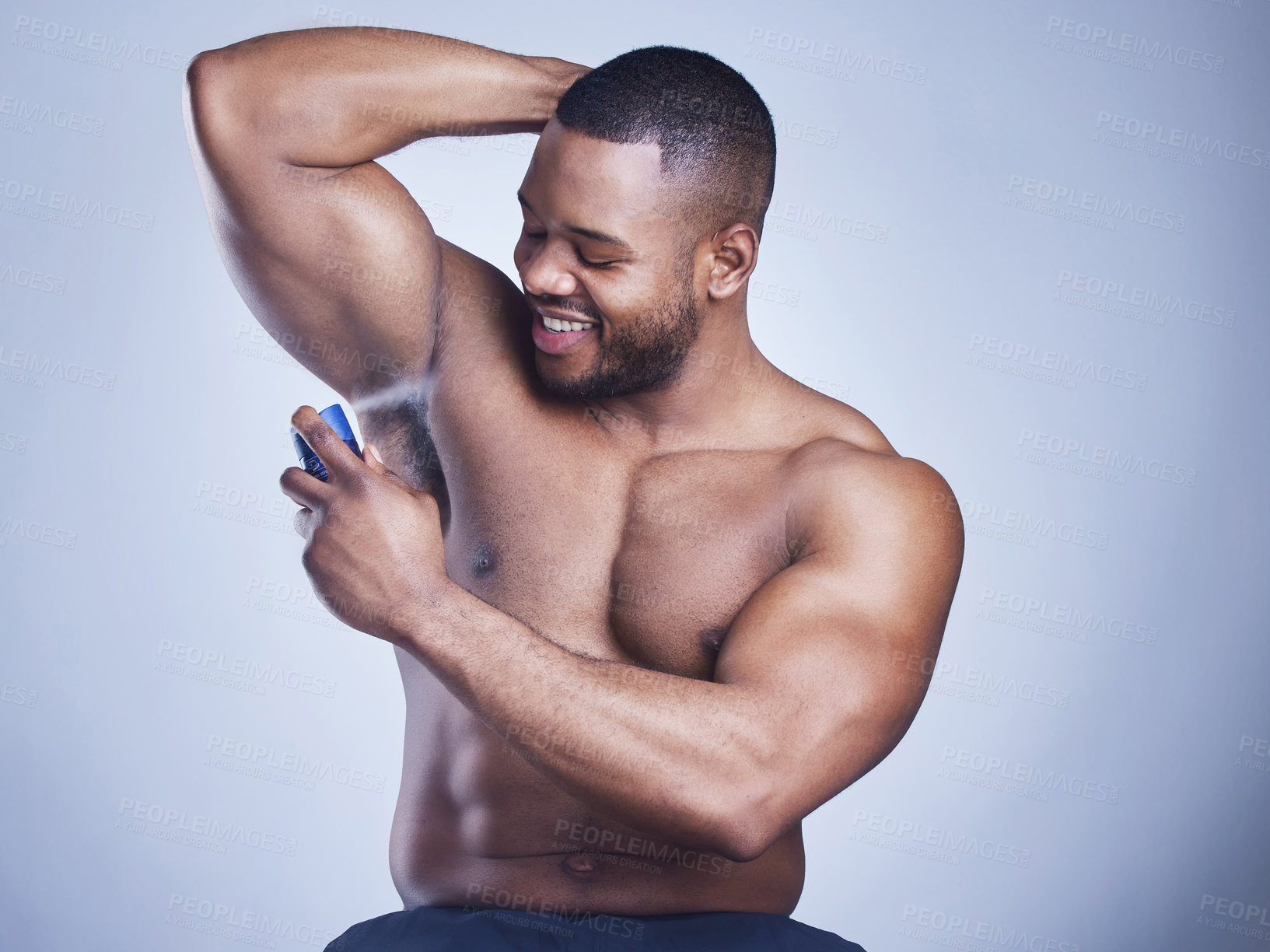 Buy stock photo Black man, cologne and spray in studio for beauty, underarm and perfume bottle on blue background. Person, deodorant and armpit for aroma or fresh scent, clean smell and shirtless for fragrance